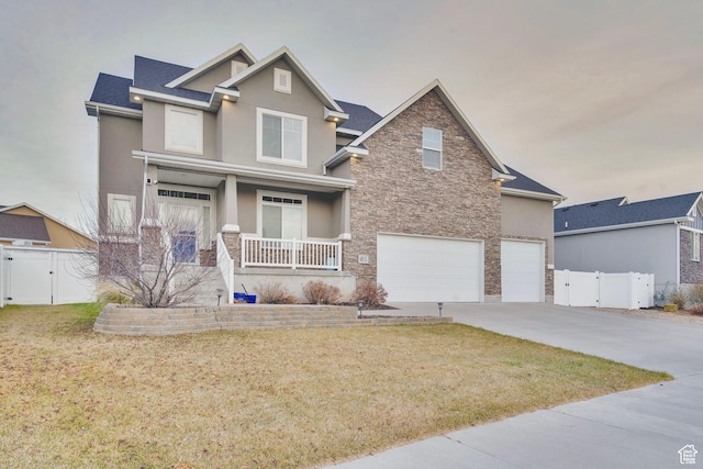 681 S Vance Dr W, Layton, UT 84041 - view of front facade with a gate, covered porch, stone siding, and stucco siding