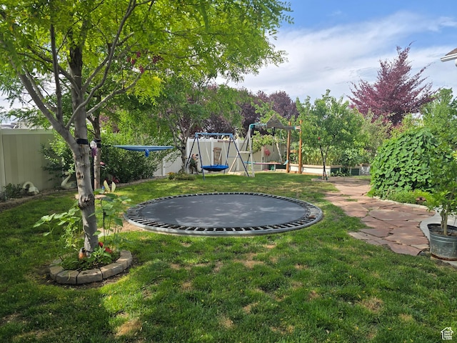 8894 S Sun Leaf Dr, West Jordan, UT 84088 - view of yard featuring a trampoline and a playground