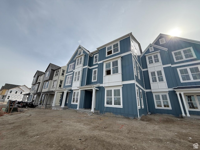 multi unit property with board and batten siding and a residential view