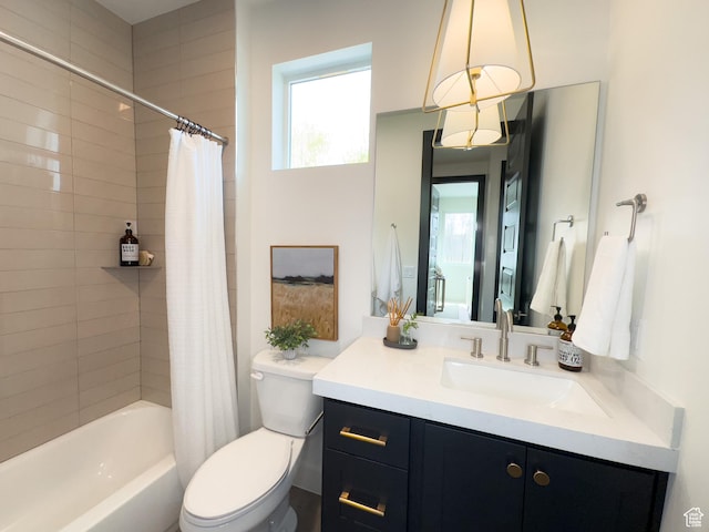 bathroom featuring shower / tub combo with curtain, toilet, and vanity