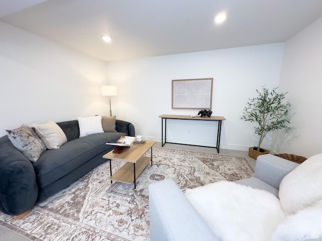 living area featuring baseboards and recessed lighting