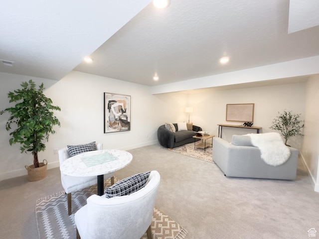 living area featuring baseboards, carpet floors, and recessed lighting