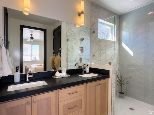 ensuite bathroom with connected bathroom, a sink, and a healthy amount of sunlight