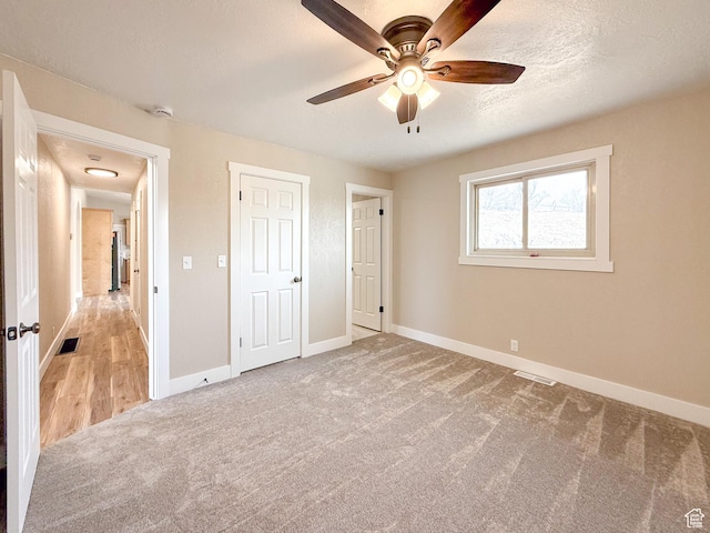 510 W Highway Dr, Wellington, UT 84542 - unfurnished bedroom with baseboards, visible vents, carpet floors, and a textured ceiling