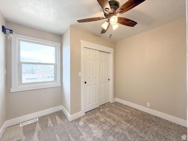 510 W Highway Dr, Wellington, UT 84542 - unfurnished bedroom featuring baseboards, visible vents, a closet, and light colored carpet