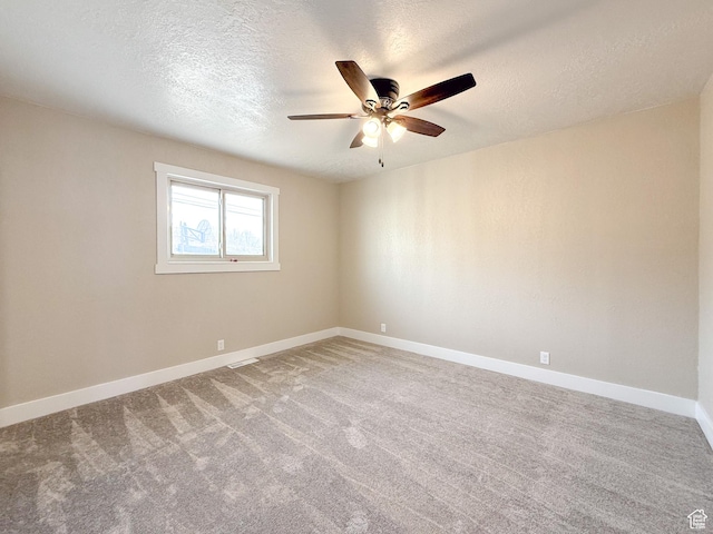 510 W Highway Dr, Wellington, UT 84542 - spare room with carpet floors, baseboards, ceiling fan, and a textured ceiling