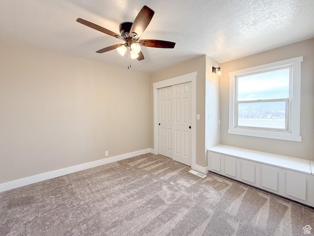 510 W Highway Dr, Wellington, UT 84542 - unfurnished bedroom with baseboards, a textured ceiling, a closet, and light colored carpet