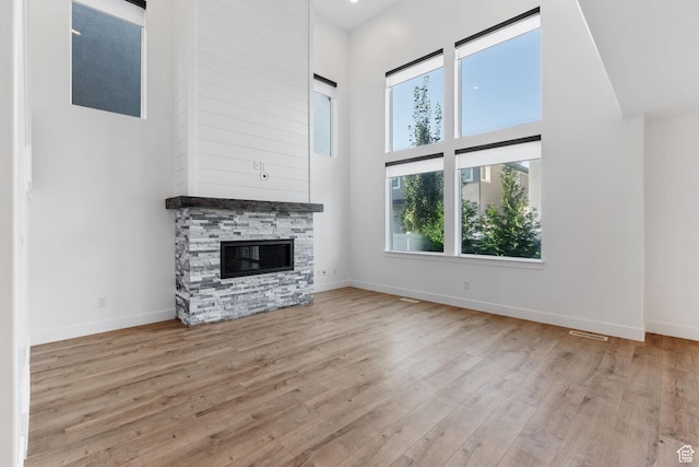 951 W Cushing Rd, Bluffdale, UT 84065 - unfurnished living room with baseboards, wood finished floors, and a towering ceiling