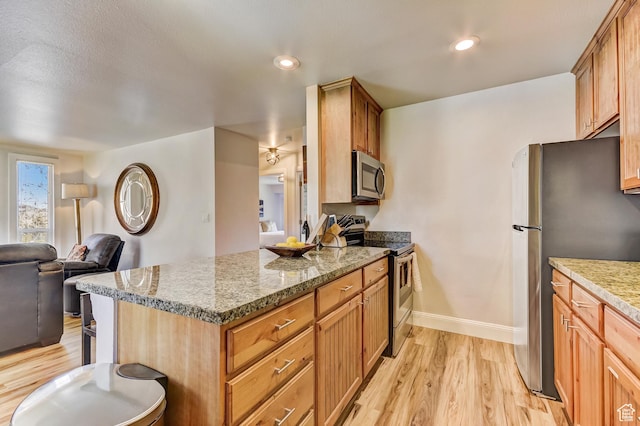 1637 Village Round Dr Unit 8, Park City, UT 84098 - kitchen with open floor plan, baseboards, light wood-style floors, a peninsula, and appliances with stainless steel finishes