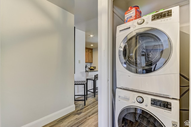 1637 Village Round Dr Unit 8, Park City, UT 84098 - laundry area with stacked washer and dryer, baseboards, light wood-style flooring, and laundry area