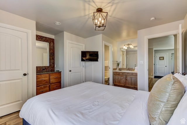 1637 Village Round Dr Unit 8, Park City, UT 84098 - bedroom featuring ensuite bathroom, wood finished floors, and a notable chandelier