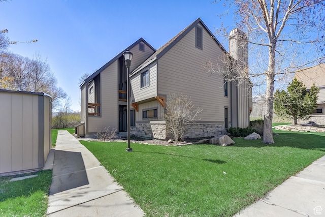 1637 Village Round Dr Unit 8, Park City, UT 84098 - view of property exterior featuring stone siding, a chimney, an outdoor structure, and a yard
