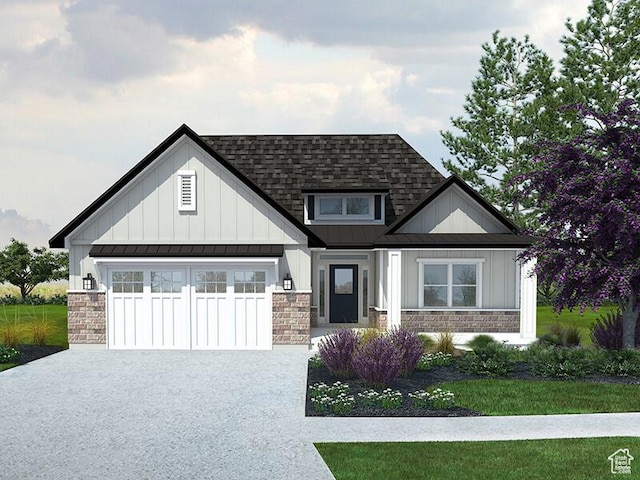 view of front of property featuring driveway, stone siding, and board and batten siding