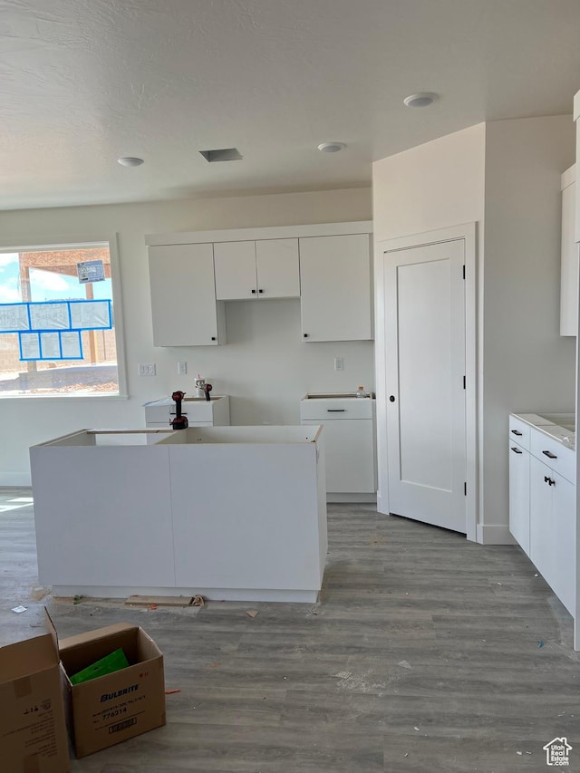 330 W Rosie Loop Unit 45E, Cedar City, UT 84720 - kitchen with white cabinets, wood finished floors, a center island, and recessed lighting