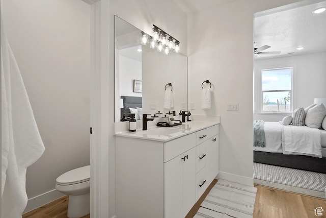 330 W Rosie Loop Unit 45E, Cedar City, UT 84720 - full bath featuring connected bathroom, wood finished floors, toilet, vanity, and baseboards