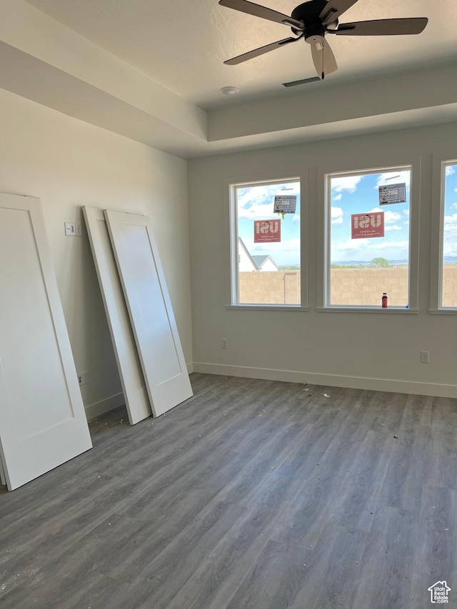 330 W Rosie Loop Unit 45E, Cedar City, UT 84720 - unfurnished bedroom with dark wood finished floors, multiple windows, baseboards, and ceiling fan