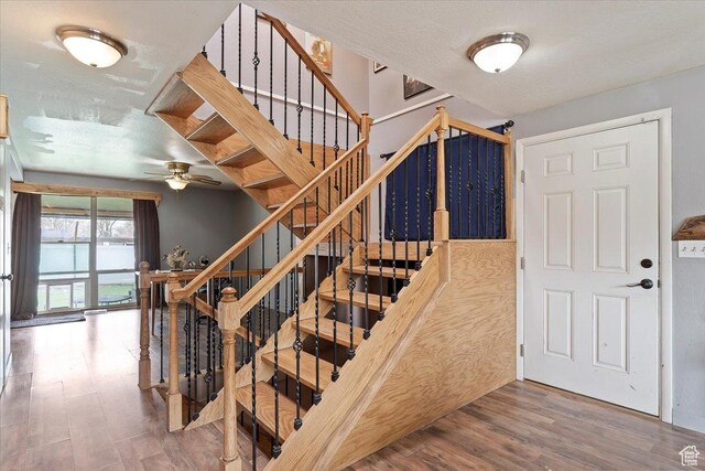 613 N 100 E, Brigham City, UT 84302 - stairs with a textured ceiling, ceiling fan, and wood finished floors