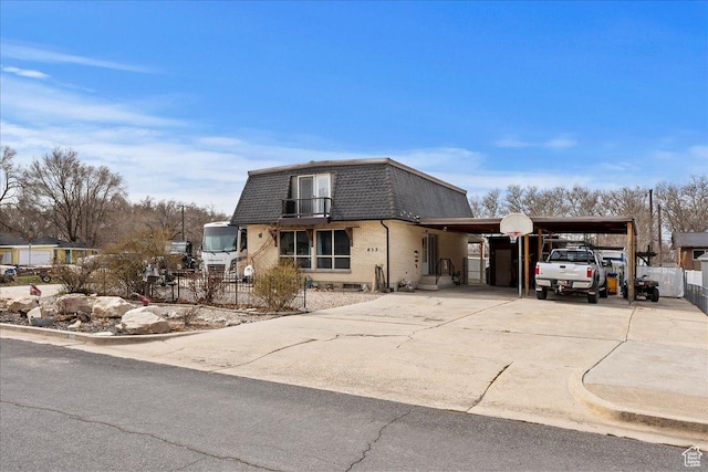 613 N 100 E, Brigham City, UT 84302 - view of front of house featuring concrete driveway, fence, roof with shingles, mansard roof, and an attached carport