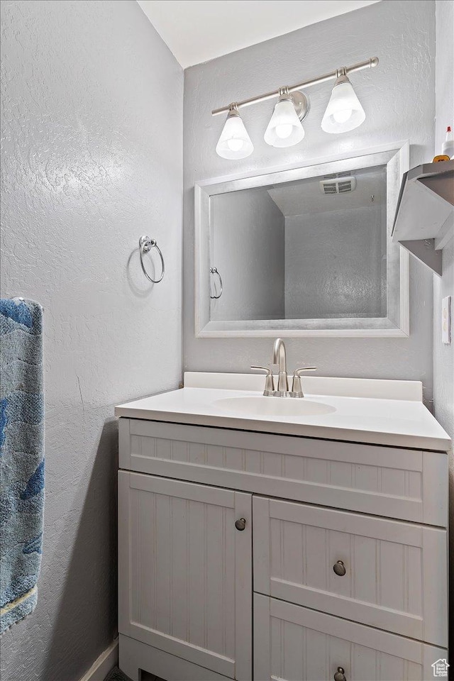 613 N 100 E, Brigham City, UT 84302 - bathroom featuring a textured wall, visible vents, and vanity