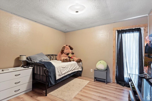 613 N 100 E, Brigham City, UT 84302 - bedroom featuring a textured ceiling, a textured wall, and light wood-style floors
