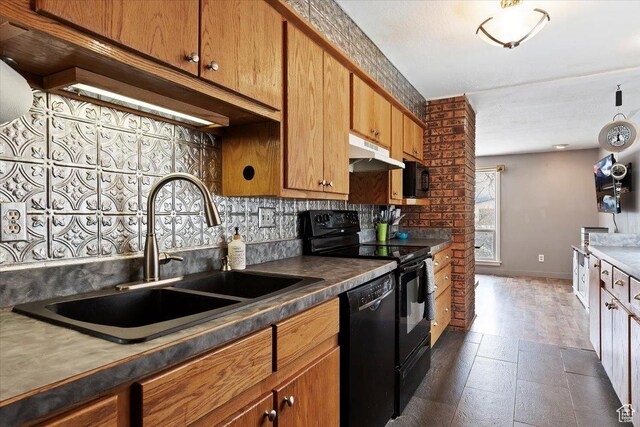 613 N 100 E, Brigham City, UT 84302 - kitchen with baseboards, under cabinet range hood, decorative backsplash, a sink, and black appliances
