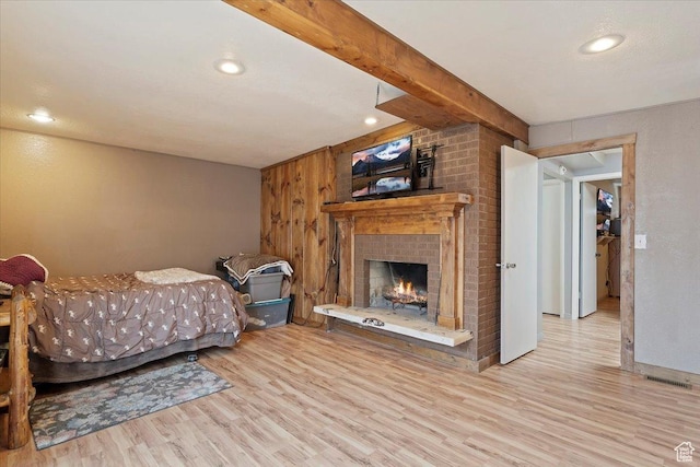 613 N 100 E, Brigham City, UT 84302 - bedroom featuring wood finished floors, beam ceiling, recessed lighting, and a brick fireplace