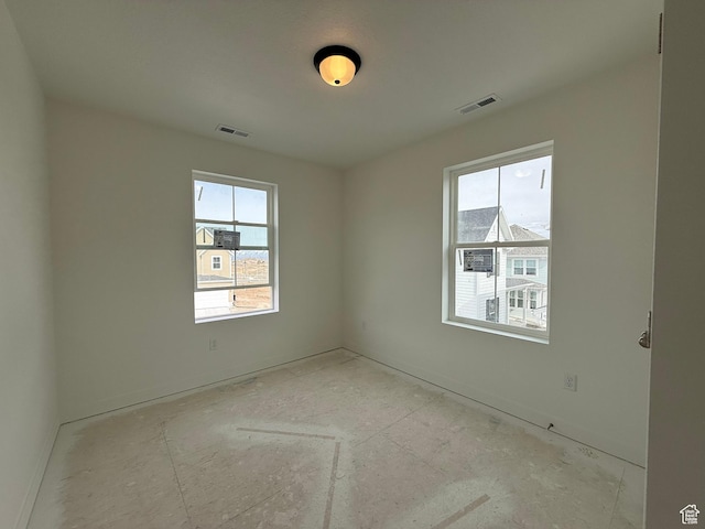 spare room with plenty of natural light and visible vents