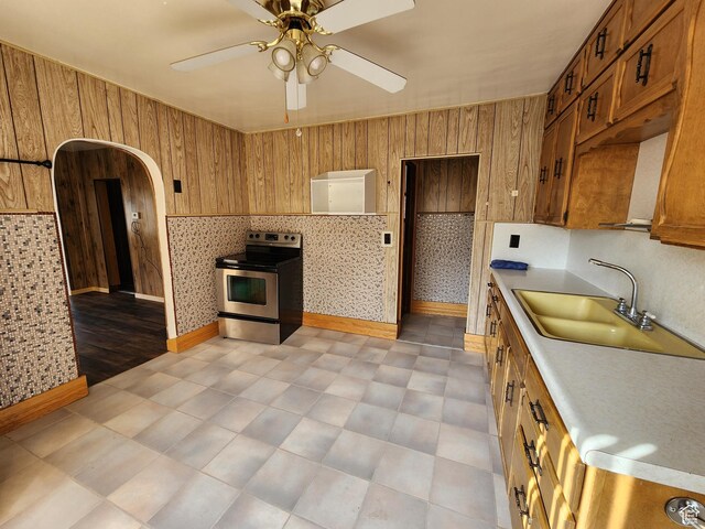 383 S 100 W, Price, UT 84501 - kitchen featuring stainless steel range with electric cooktop, brown cabinetry, light countertops, a ceiling fan, and a sink