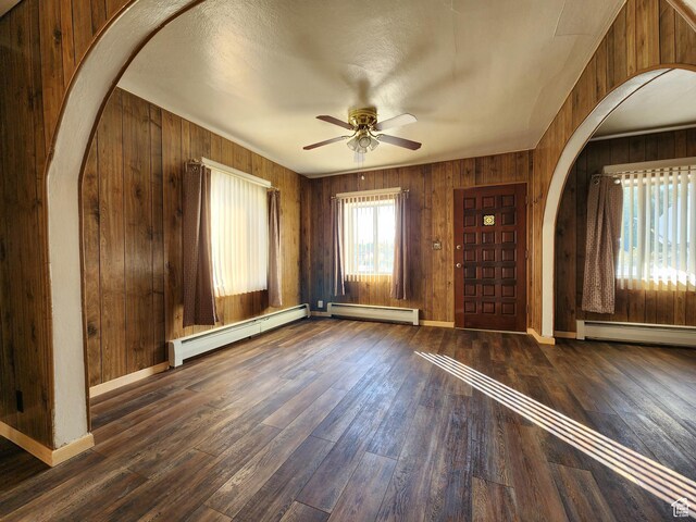 383 S 100 W, Price, UT 84501 - foyer featuring a baseboard radiator, arched walkways, a ceiling fan, and wooden walls