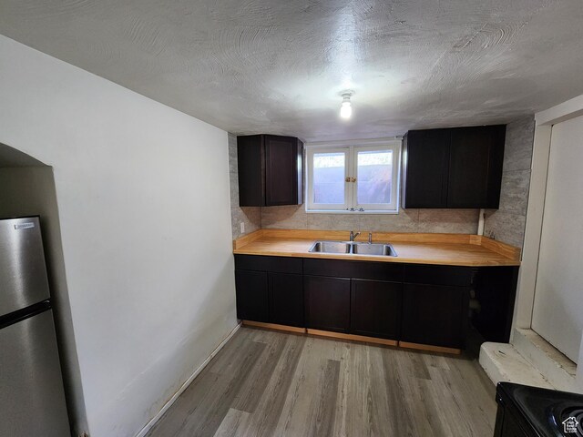 383 S 100 W, Price, UT 84501 - kitchen featuring a sink, freestanding refrigerator, light wood-type flooring, light countertops, and baseboards