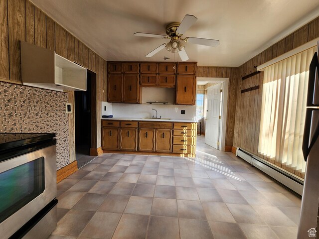 383 S 100 W, Price, UT 84501 - kitchen with electric range, a baseboard heating unit, light countertops, ceiling fan, and wood walls