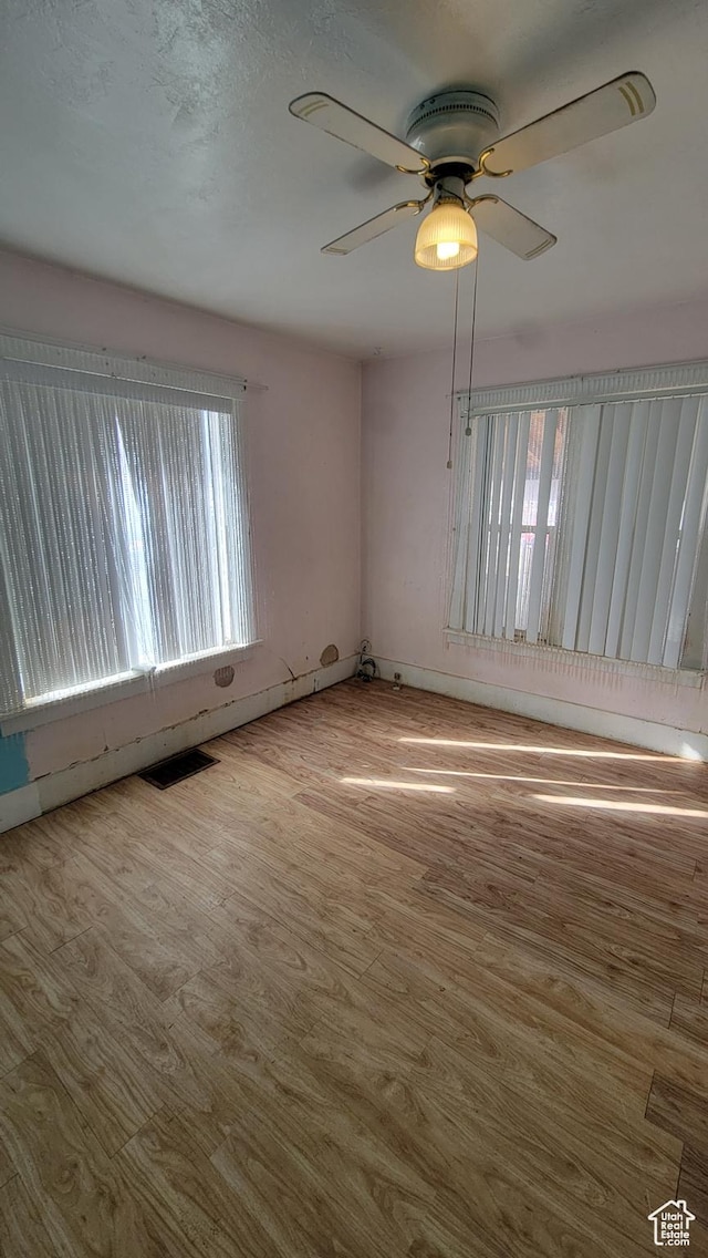 390 S 400 W, Logan, UT 84321 - unfurnished room with visible vents, a ceiling fan, and wood finished floors