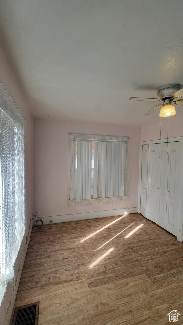 390 S 400 W, Logan, UT 84321 - unfurnished bedroom with a ceiling fan, visible vents, a closet, and wood finished floors