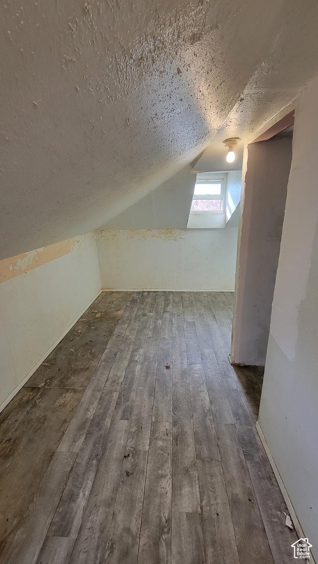 390 S 400 W, Logan, UT 84321 - additional living space featuring a textured ceiling, vaulted ceiling, and wood-type flooring