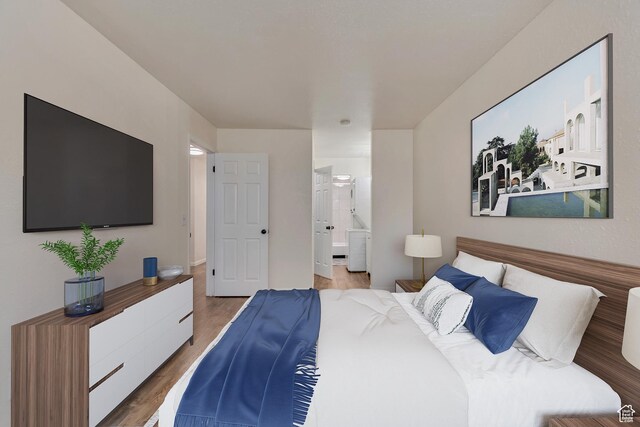 742 S 400 E Unit H102, Salt Lake City, UT 84111 - bedroom featuring ensuite bathroom and wood finished floors