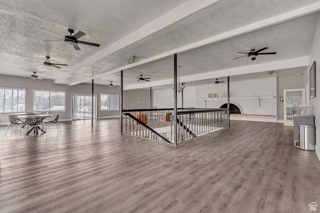 742 S 400 E Unit H102, Salt Lake City, UT 84111 - interior space with a textured ceiling, wood finished floors, a ceiling fan, and a brick fireplace