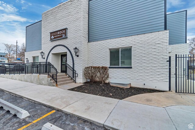 742 S 400 E Unit H102, Salt Lake City, UT 84111 - exterior space with uncovered parking, a gate, and brick siding