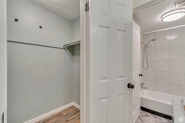 742 S 400 E Unit H102, Salt Lake City, UT 84111 - full bathroom featuring visible vents, baseboards, wood finished floors, bathing tub / shower combination, and a textured wall