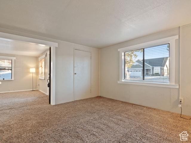 unfurnished bedroom with carpet flooring and a textured ceiling