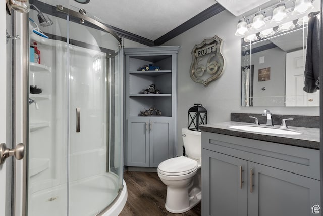12381 S 3600 W, Riverton, UT 84065 - bathroom featuring a stall shower, toilet, vanity, wood finished floors, and ornamental molding