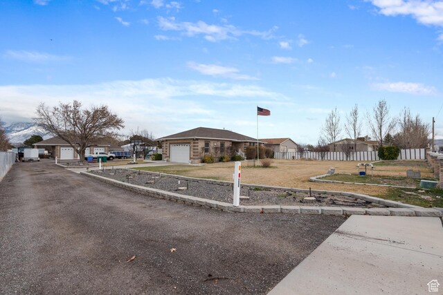 12381 S 3600 W, Riverton, UT 84065 - view of front of house with a residential view, concrete driveway, a garage, and fence