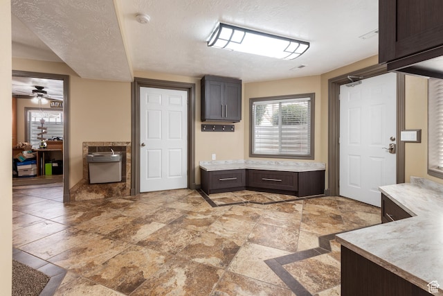 12381 S 3600 W, Riverton, UT 84065 - kitchen with a textured ceiling, light countertops, dark brown cabinets, and ceiling fan