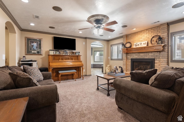 12381 S 3600 W, Riverton, UT 84065 - carpeted living area with a fireplace, a textured ceiling, visible vents, arched walkways, and ornamental molding