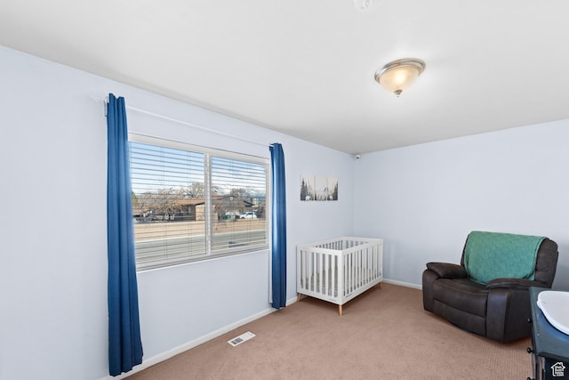 sitting room with baseboards, visible vents, and carpet flooring