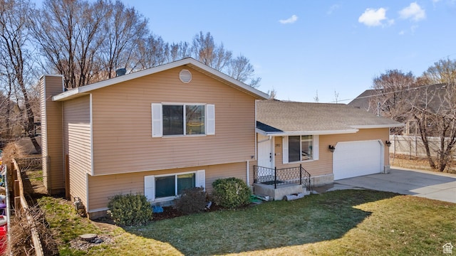 split level home with a front yard, driveway, a garage, and a shingled roof