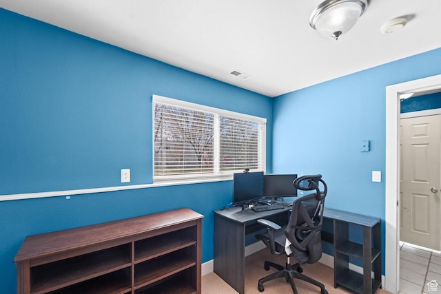 office space featuring baseboards and visible vents