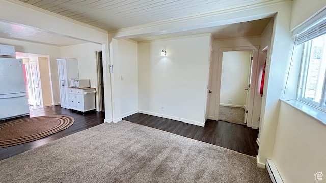 interior space with a baseboard radiator, baseboards, and dark wood-style floors
