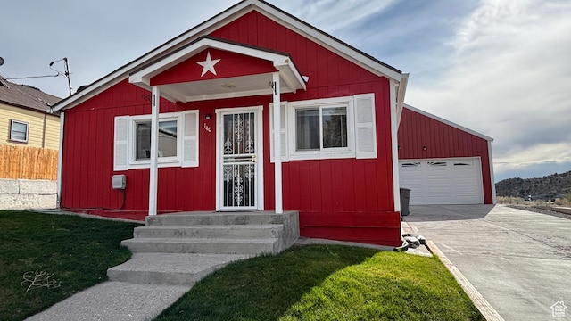 view of front of home with a front lawn, concrete driveway, fence, a garage, and entry steps