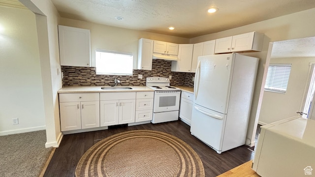 kitchen with a sink, decorative backsplash, white appliances, white cabinetry, and dark wood-style flooring