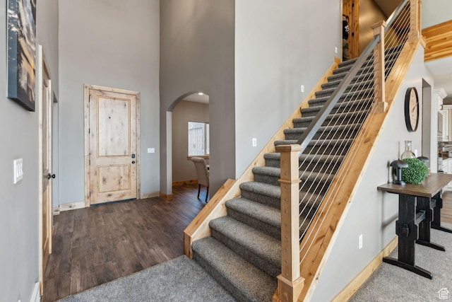 1101 E Stage Coach Run N, Morgan, UT 84050 - entrance foyer featuring baseboards, stairs, a towering ceiling, wood finished floors, and arched walkways